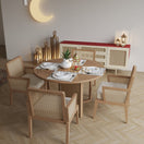 Switch Dining area with round wooden table and four rattan chairs 1 image